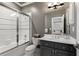 Bathroom featuring shower with glass enclosure and dark grey vanity offering practical elegance at 1160 Lake Shore Overlook, Alpharetta, GA 30005
