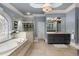 Elegant bathroom showcasing a soaking tub, walk-in shower and and sinks at 1160 Lake Shore Overlook, Alpharetta, GA 30005
