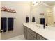 Updated bathroom featuring gray cabinets, white quartz countertop, and a glass enclosed shower at 1160 Lake Shore Overlook, Alpharetta, GA 30005