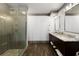 Bathroom with a large glass shower and dark wood cabinets with light countertops at 1160 Lake Shore Overlook, Alpharetta, GA 30005