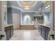 Luxurious bathroom featuring a soaking tub, glass enclosed shower, and dual sink vanities at 1160 Lake Shore Overlook, Alpharetta, GA 30005