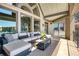 Covered patio with cozy seating, scenic lake views, and brick columns at 1160 Lake Shore Overlook, Alpharetta, GA 30005
