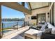 Covered patio with comfortable seating area overlooking the lake and pool at 1160 Lake Shore Overlook, Alpharetta, GA 30005
