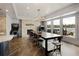 An open basement dining area with fireplace and lake views featuring stylish design and natural light at 1160 Lake Shore Overlook, Alpharetta, GA 30005