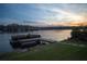 Dock with a pontoon boat sitting on the lake at sunset at 1160 Lake Shore Overlook, Alpharetta, GA 30005