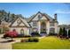 Stunning two-story brick home with manicured lawn and mature landscaping at 1160 Lake Shore Overlook, Alpharetta, GA 30005