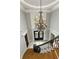 Grand foyer featuring a staircase and a stunning chandelier hanging from the ceiling at 1160 Lake Shore Overlook, Alpharetta, GA 30005
