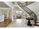 Elegant foyer with staircase, black and white tile, and hardwood floors at 1160 Lake Shore Overlook, Alpharetta, GA 30005