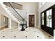 Grand foyer featuring high ceilings, tile flooring, and elegant staircase at 1160 Lake Shore Overlook, Alpharetta, GA 30005