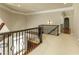 Hallway with decorative wrought iron railing and a view of the main entry with glass front door at 1160 Lake Shore Overlook, Alpharetta, GA 30005