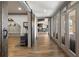 Hallway features wood floors, barn door, exercise equipment and multiple glass doors to patio at 1160 Lake Shore Overlook, Alpharetta, GA 30005