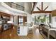 Open kitchen with a large island, stainless steel appliances, hardwood floors, and a view to the eat-in dining area at 1160 Lake Shore Overlook, Alpharetta, GA 30005