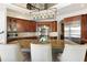 Spacious kitchen with a large granite island, stainless appliances, and custom wood cabinets under decorative lighting at 1160 Lake Shore Overlook, Alpharetta, GA 30005