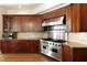 The gourmet kitchen boasts granite countertops, custom cabinetry, stainless steel appliances, and tiled backsplash at 1160 Lake Shore Overlook, Alpharetta, GA 30005