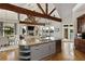 Open concept kitchen with a large island, stainless steel appliances, hardwood floors, and lake views at 1160 Lake Shore Overlook, Alpharetta, GA 30005