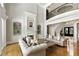 Elegant living room features a fireplace, built-in shelving, high ceilings, and hardwood floors, creating a luxurious space at 1160 Lake Shore Overlook, Alpharetta, GA 30005