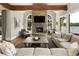 Cozy living room with stone fireplace, wood beams, and a large window with lake view at 1160 Lake Shore Overlook, Alpharetta, GA 30005