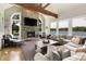 Bright living room featuring a stone fireplace, a large sectional sofa and lake views at 1160 Lake Shore Overlook, Alpharetta, GA 30005