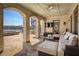 Covered outdoor living area with comfortable seating, fireplace, and lake views, great for entertaining at 1160 Lake Shore Overlook, Alpharetta, GA 30005