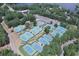 Aerial view of multiple well-maintained tennis courts surrounded by lush greenery at 1160 Lake Shore Overlook, Alpharetta, GA 30005