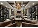 Unique wine cellar with custom racks, brick accents, barrel table and leather seating creates inviting ambiance at 1160 Lake Shore Overlook, Alpharetta, GA 30005