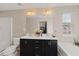 Bathroom featuring double sinks, a large mirror, a tub, and a window at 5076 Longview Walk, Decatur, GA 30035