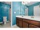 Stylish bathroom featuring double sinks, a toilet, and a glass-enclosed shower at 531 Rokeby Dr, Woodstock, GA 30188