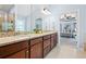 Bathroom with dual sinks, granite countertops, walk-in shower and entry to main bedroom at 531 Rokeby Dr, Woodstock, GA 30188