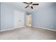 This bedroom features a ceiling fan, double doors and carpet, providing a cozy retreat at 531 Rokeby Dr, Woodstock, GA 30188