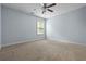 This bedroom offers a serene atmosphere with a ceiling fan and a bright window at 531 Rokeby Dr, Woodstock, GA 30188
