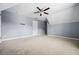 This carpeted bedroom is complete with ceiling fan, neutral walls, and plenty of space at 531 Rokeby Dr, Woodstock, GA 30188