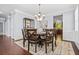Dining room featuring hardwood floors, a chandelier, and space for six chairs at 531 Rokeby Dr, Woodstock, GA 30188
