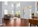 Elegant foyer with soaring ceilings, hardwood floors, and a view of the living area at 531 Rokeby Dr, Woodstock, GA 30188