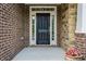 A front door flanked by sidelights, set in a brick and stone facade at 531 Rokeby Dr, Woodstock, GA 30188