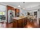 Kitchen with hardwood floors, granite countertops, stainless steel appliances and views to other common areas at 531 Rokeby Dr, Woodstock, GA 30188