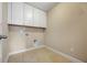 This functional laundry room includes tile flooring, built-in cabinets, and essential hook-ups at 531 Rokeby Dr, Woodstock, GA 30188