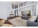 Open living area with high ceilings, hardwood floors, and a glimpse into the dining space at 531 Rokeby Dr, Woodstock, GA 30188