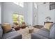 Bright living room featuring high ceilings, hardwood floors, and comfortable couches at 531 Rokeby Dr, Woodstock, GA 30188