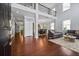 Open-concept living room with high ceilings, hardwood floors, and a view of the dining area at 531 Rokeby Dr, Woodstock, GA 30188