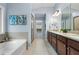 Large bathroom featuring dual vanities, soaking tub, and walk-in shower at 531 Rokeby Dr, Woodstock, GA 30188