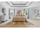 Bright main bedroom featuring stylish rug, lamps, trey ceiling and large windows at 531 Rokeby Dr, Woodstock, GA 30188