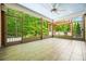 Screened-in porch featuring tile flooring, ceiling fan, and a view of the lush green backyard at 531 Rokeby Dr, Woodstock, GA 30188