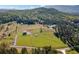 Expansive aerial view of a property featuring lush pastures, mature trees, and mountain views at 96 Landers Ne Rd, Rydal, GA 30171