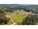 Scenic aerial view of pastures, trees, and mountain views showcasing the expansive property at 96 Landers Ne Rd, Rydal, GA 30171