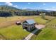 View of the barn, boasting a metal roof, positioned on a well-maintained grassy lot at 96 Landers Ne Rd, Rydal, GA 30171