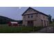 Evening exterior of the barn with a metal roof and adjacent outbuilding, bathed in soft moonlight at 96 Landers Ne Rd, Rydal, GA 30171