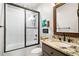 Well-lit bathroom featuring a tiled shower with glass doors and vanity with a granite countertop at 96 Landers Ne Rd, Rydal, GA 30171