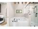 Cozy bathroom featuring a soaking tub, glass shower, and laundry hook-ups at 96 Landers Ne Rd, Rydal, GA 30171