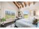 Bright bedroom with large windows offering a beautiful view of nature and wood beam ceiling at 96 Landers Ne Rd, Rydal, GA 30171