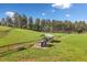 Picturesque meadow featuring a modern chicken coop with run and fencing on a sunny day at 96 Landers Ne Rd, Rydal, GA 30171